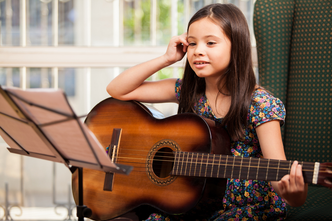 Little girl during a guitar lesson